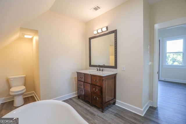 bathroom featuring vaulted ceiling, hardwood / wood-style floors, and toilet