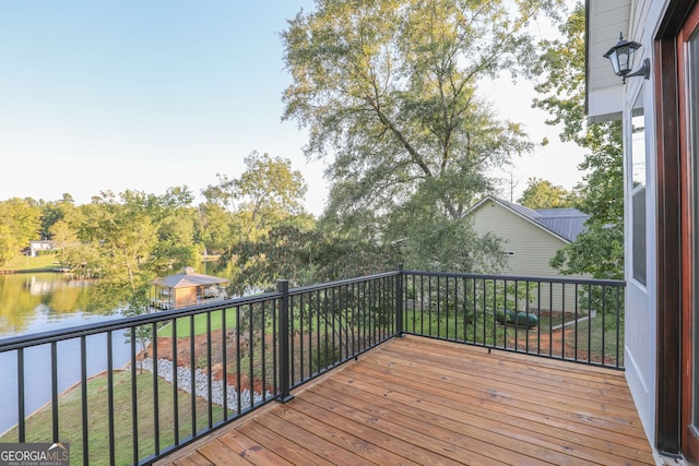 deck with a yard and a water view