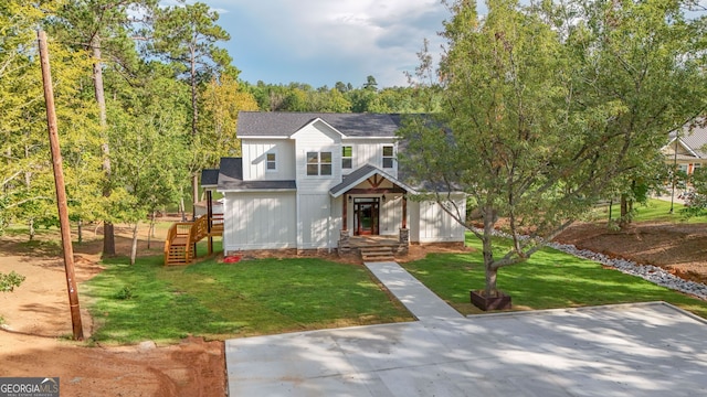 view of front of property with a front lawn and board and batten siding