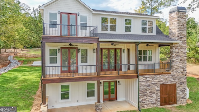 exterior space featuring french doors, a front yard, and a ceiling fan