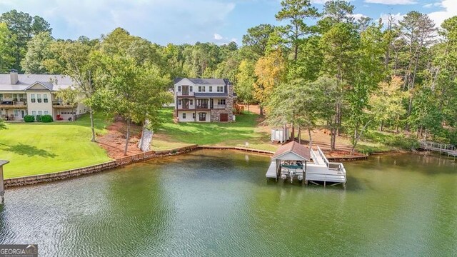 dock area featuring a water view and a lawn