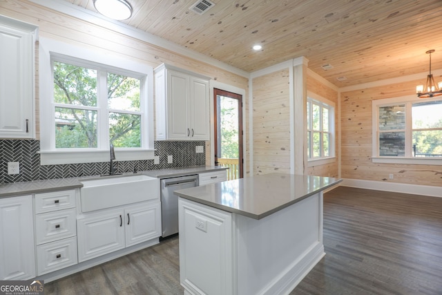 kitchen with dishwasher, a center island, white cabinetry, dark wood-type flooring, and decorative backsplash