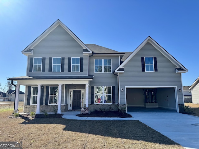 view of front of property with covered porch and a garage