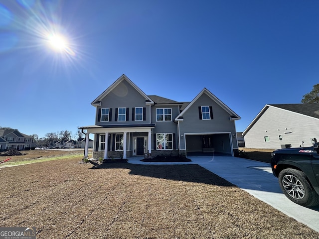 view of property featuring a porch and a garage