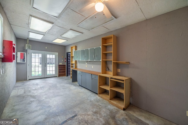 unfurnished office featuring ceiling fan and french doors