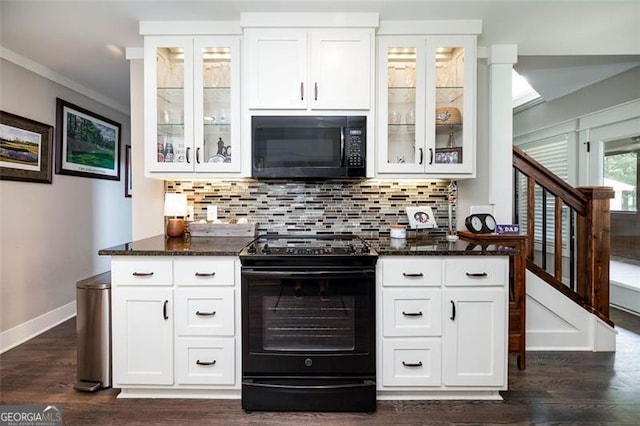 kitchen featuring dark stone counters, dark wood-type flooring, decorative backsplash, white cabinetry, and range with electric stovetop