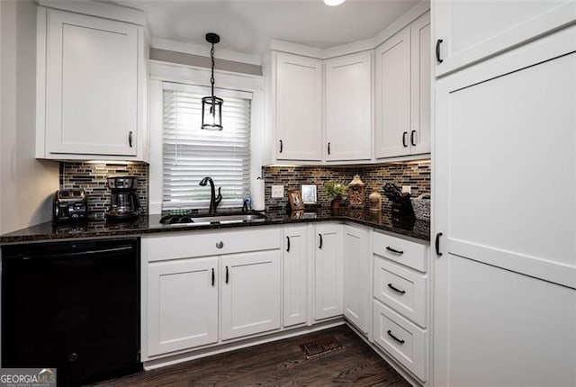 kitchen featuring dishwasher, white cabinets, hanging light fixtures, and a sink