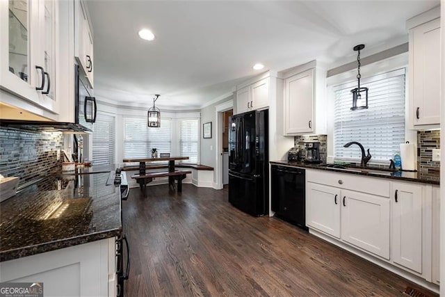 kitchen featuring black appliances, white cabinets, dark wood finished floors, and hanging light fixtures