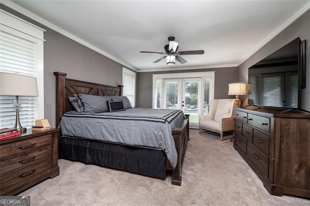 bedroom with light colored carpet, ornamental molding, and a ceiling fan