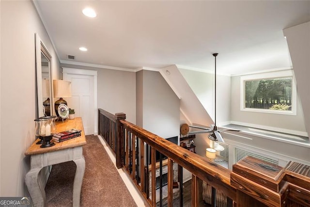 corridor featuring visible vents, an upstairs landing, carpet, and ornamental molding