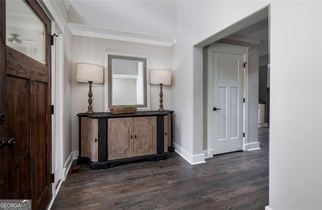 corridor featuring dark wood-style floors and baseboards