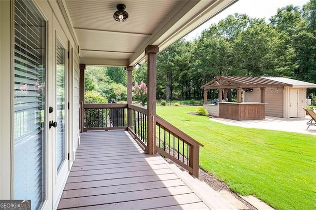 deck featuring a yard and a hot tub