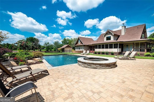 view of swimming pool with an in ground hot tub and a patio