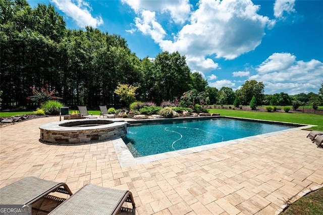 view of swimming pool with a patio area and a pool with connected hot tub