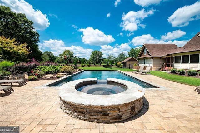 view of swimming pool with an in ground hot tub and a patio