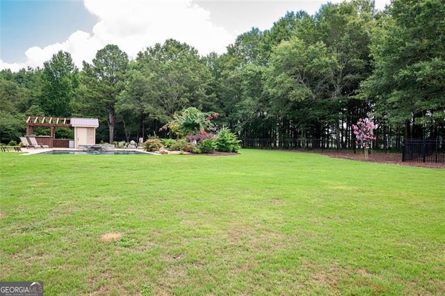 view of yard with fence and a pergola