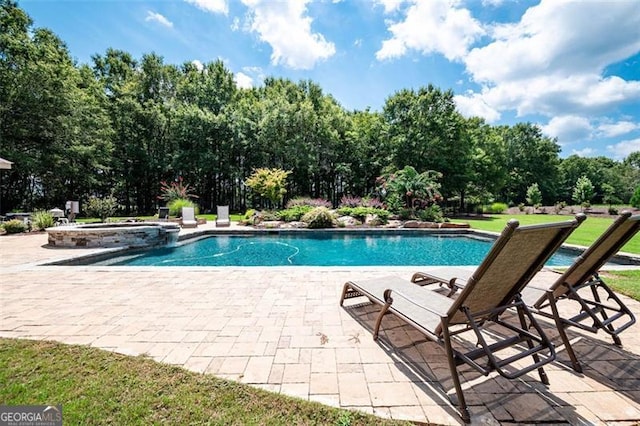 view of swimming pool with a patio area and a pool with connected hot tub