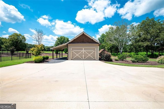 garage featuring a carport, fence, and driveway