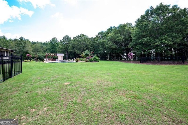 view of yard with a pergola and fence