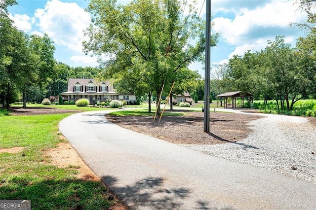 surrounding community featuring a gazebo, a yard, and driveway