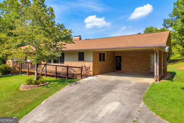 ranch-style house featuring a deck, a front yard, and a carport