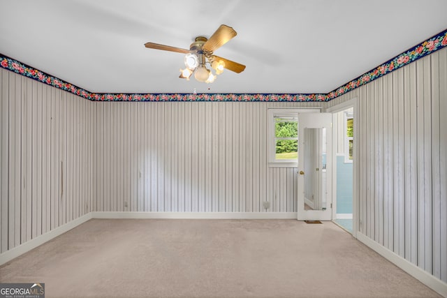 spare room featuring carpet flooring and ceiling fan