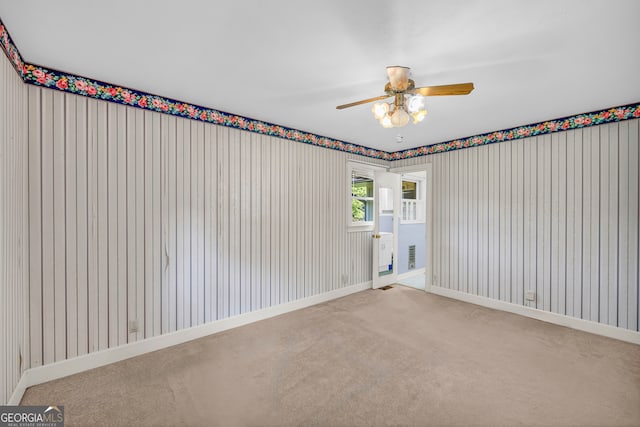 unfurnished room featuring carpet floors and ceiling fan