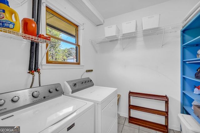 washroom with washing machine and dryer and light tile patterned floors