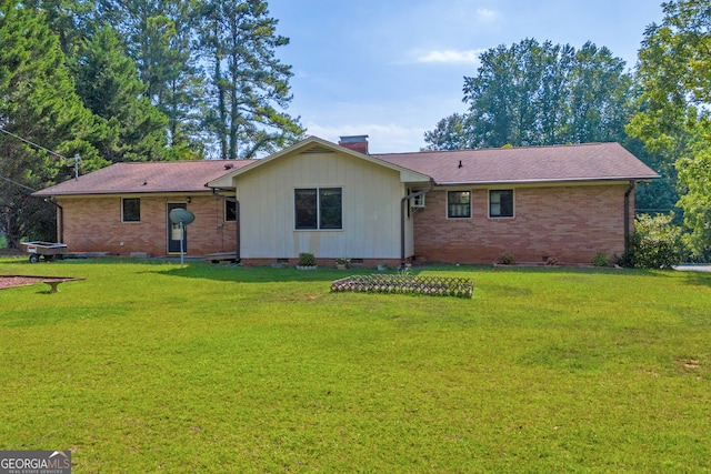 rear view of property featuring a yard