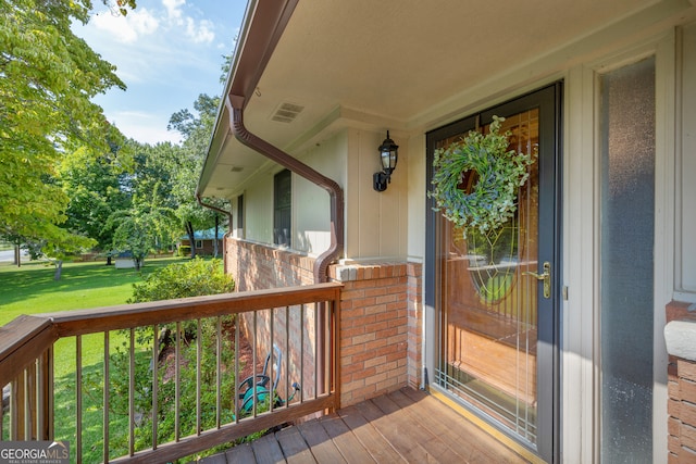 wooden terrace featuring a yard