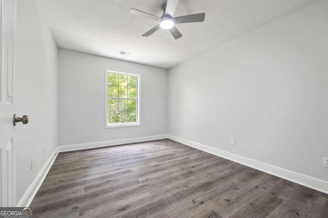 spare room featuring a textured ceiling, ceiling fan, and dark hardwood / wood-style flooring