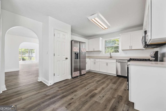 kitchen featuring a wealth of natural light, stainless steel appliances, and dark hardwood / wood-style flooring