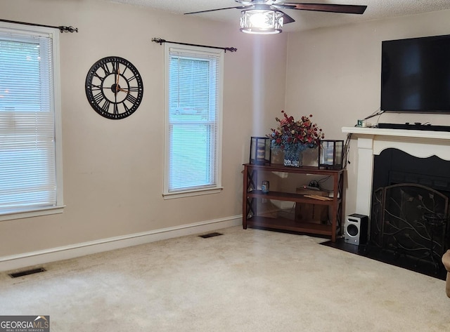 living room with ceiling fan and carpet floors