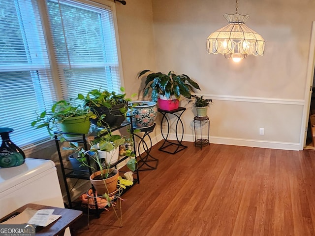 misc room featuring an inviting chandelier and wood-type flooring