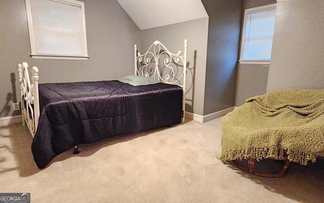 bedroom with vaulted ceiling and carpet flooring