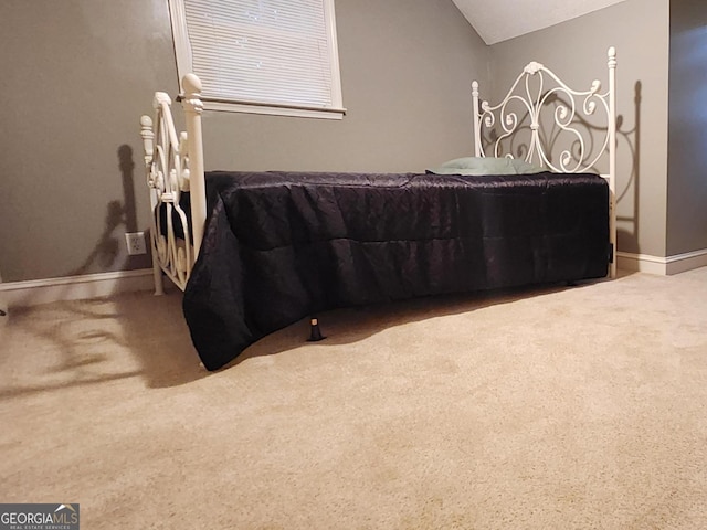 carpeted bedroom featuring lofted ceiling