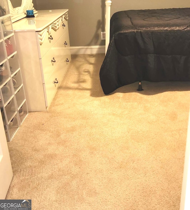 bedroom featuring light colored carpet