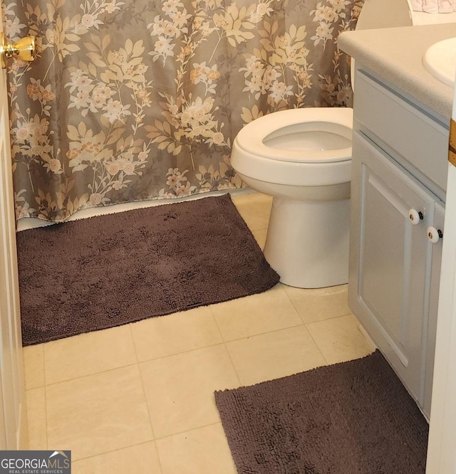 bathroom with tile patterned flooring, vanity, and toilet