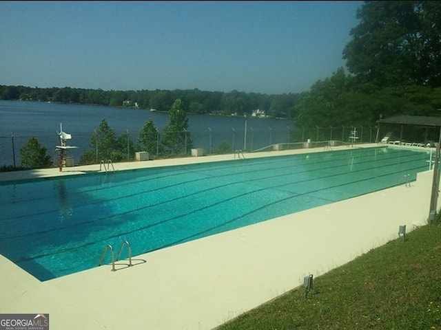 view of swimming pool with a water view