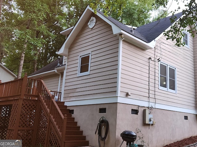 view of side of home with a deck