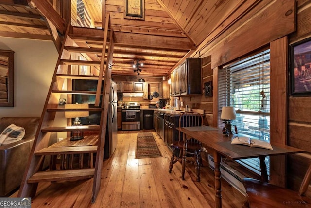 kitchen with appliances with stainless steel finishes, light hardwood / wood-style floors, vaulted ceiling, and wood ceiling