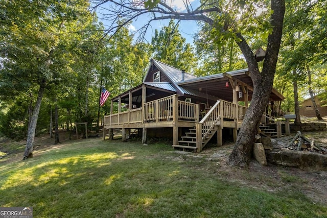 back of house with a lawn and a wooden deck