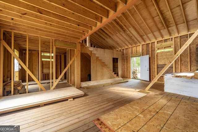 misc room featuring vaulted ceiling and wood-type flooring