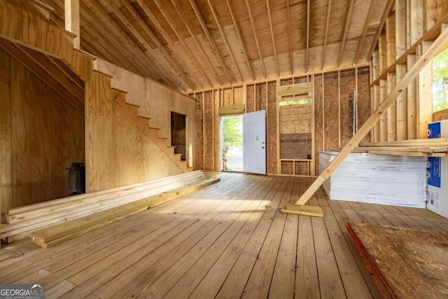 misc room with lofted ceiling and wood-type flooring