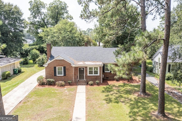 single story home with brick siding, a shingled roof, crawl space, a chimney, and a front yard