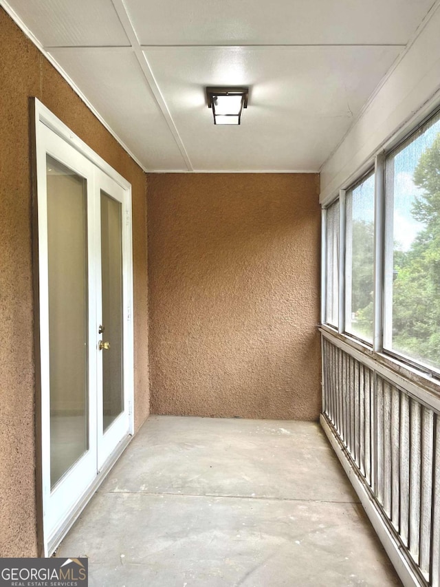 unfurnished sunroom with french doors