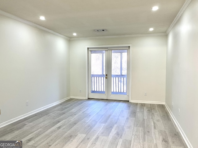 unfurnished room with baseboards, visible vents, light wood-style flooring, crown molding, and french doors