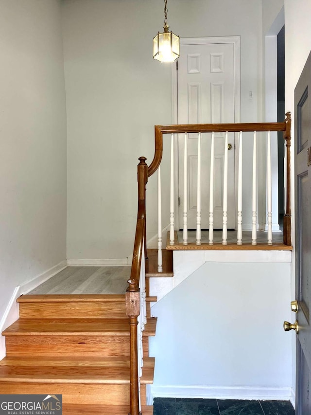 staircase featuring baseboards