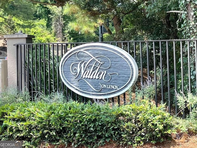 community / neighborhood sign with fence