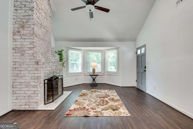 unfurnished living room with a fireplace, ceiling fan, lofted ceiling, and dark hardwood / wood-style floors